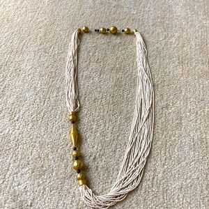 Rivers of white glass seed beads. Brass bold pieces. 1960s vintage.